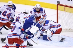 New York Rangers Alexandar Georgiev tracks the puck in a crowd of players- Photo Credit Luke Durda/In Play! Magazine