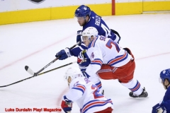 Toronto Maple Leafs Morgan Rielly and New York Ranger Filip Chytil race for the puck - Luke Durda/In Play! Magazine