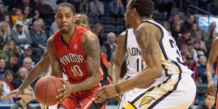 Brandon Robinson driving to the basket surrounded by three defenders